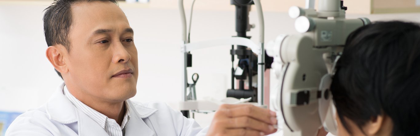 Male doctor performing an eye exam.