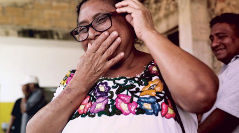Older woman overjoyed with her new glasses.
