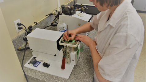 National Vision employee at a machine