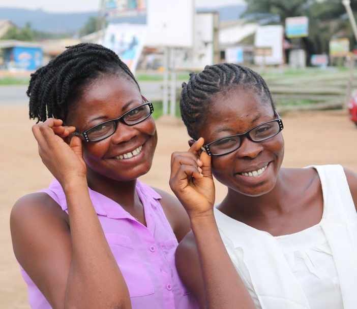 two girls in glasses smiling
