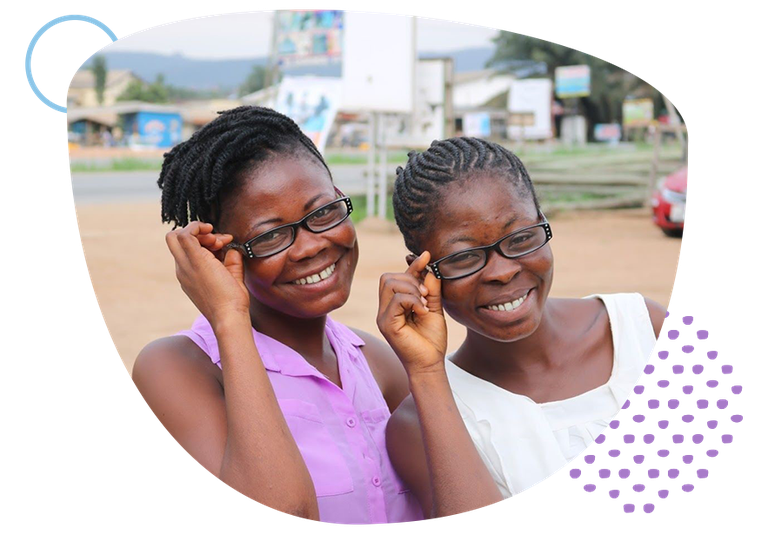 two girls smiling while wearing glasses